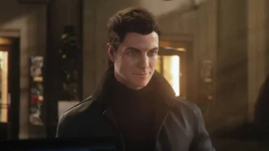 Man in dark coat indoors with warm lighting