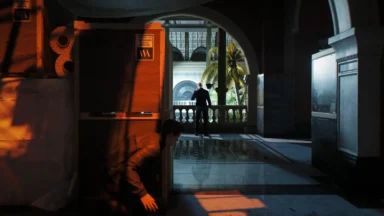Person hiding behind exhibit in museum hallway
