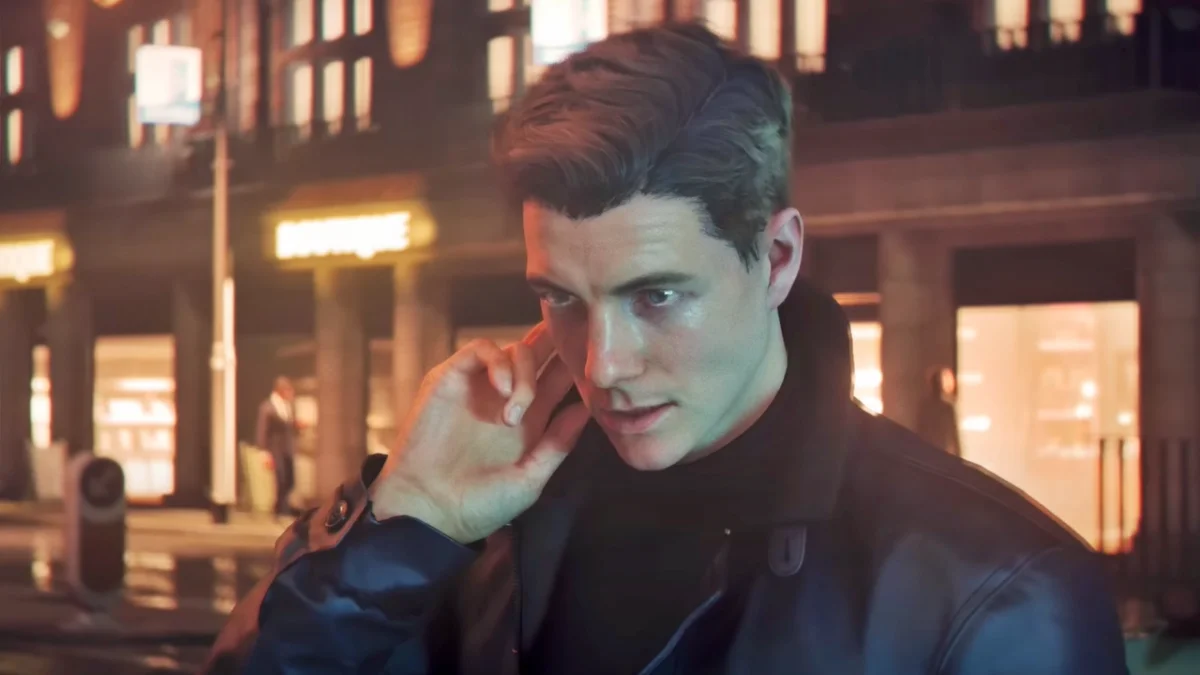Man in dark coat on city street at night