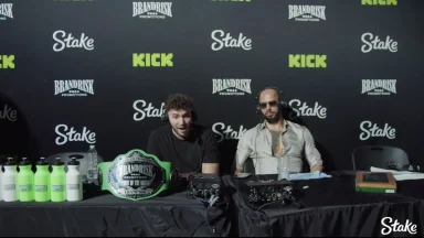 Commentators at BrandRisk event with championship belt.