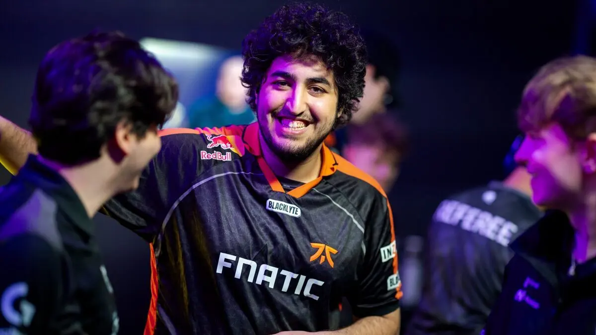 Smiling Fnatic esports player celebrating with teammates