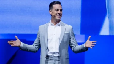 Man in gray suit speaking on stage