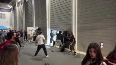 Crowd gathers during intense street confrontation