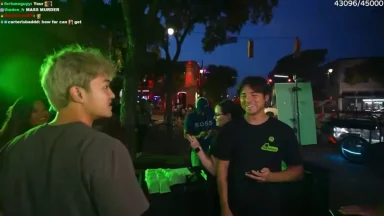 People enjoying nightlife on lively street corner.