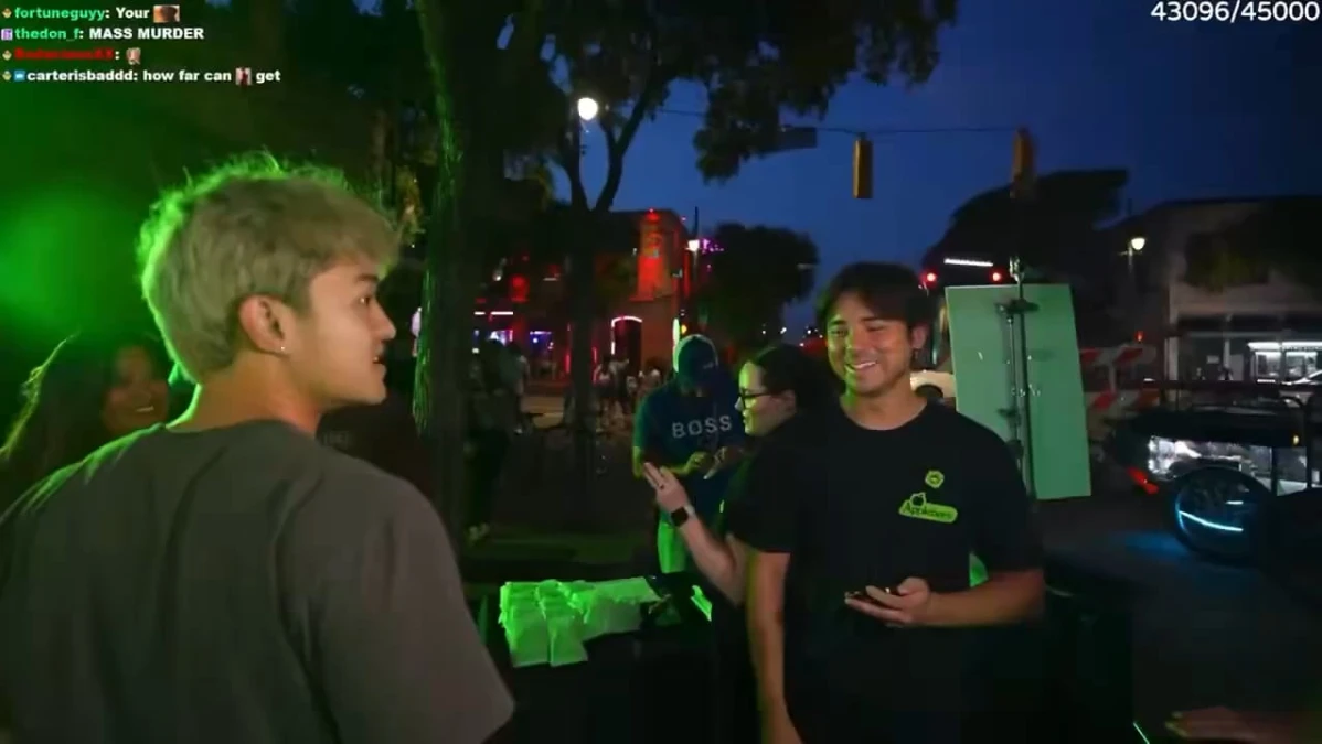 People enjoying nightlife on lively street corner.