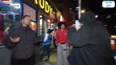 Three men arguing on city sidewalk at night
