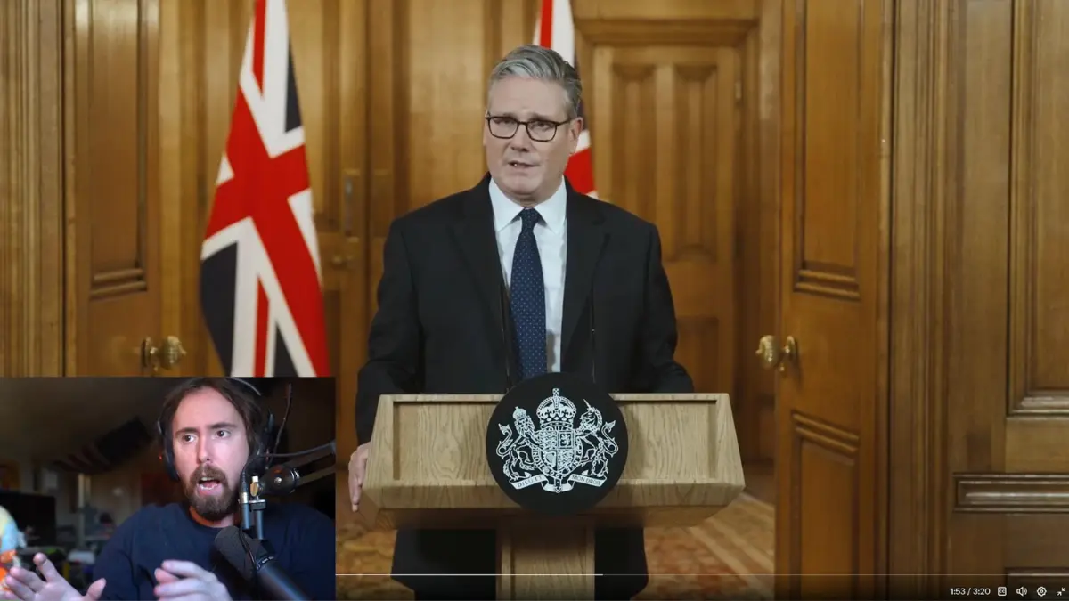 Man gives speech at podium with UK flag.