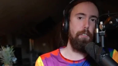Bearded man with headphones speaking into microphone