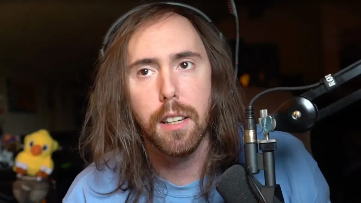 Long-haired man speaking into microphone on headset