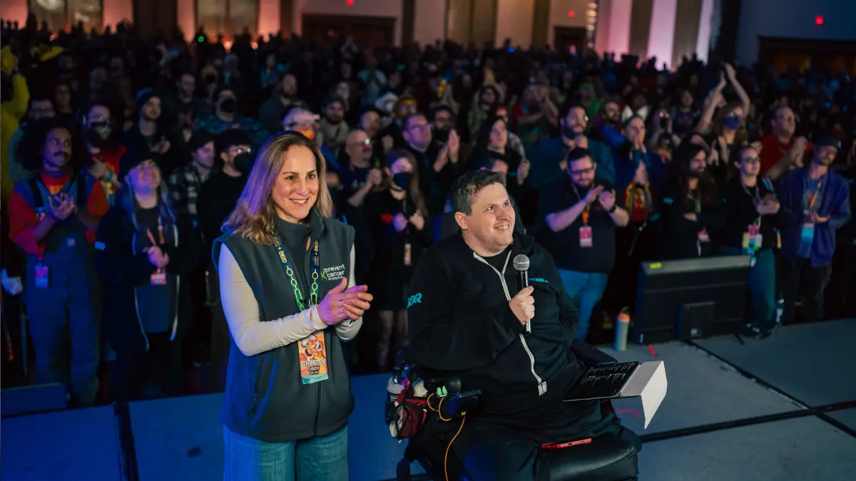 Speakers addressing enthusiastic crowd at gaming charity event