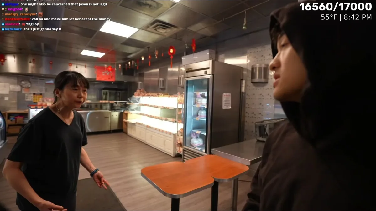 Two people talking inside a bakery shop