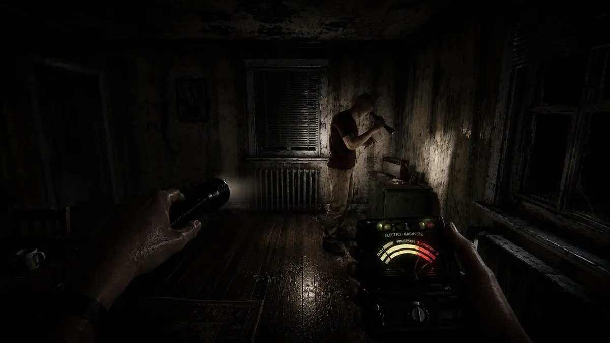Man investigating dark room with EMF meter