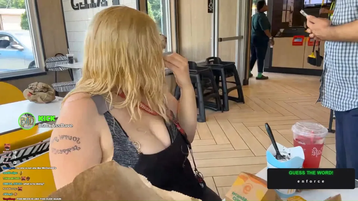 Blonde woman seated at a fast-food restaurant table