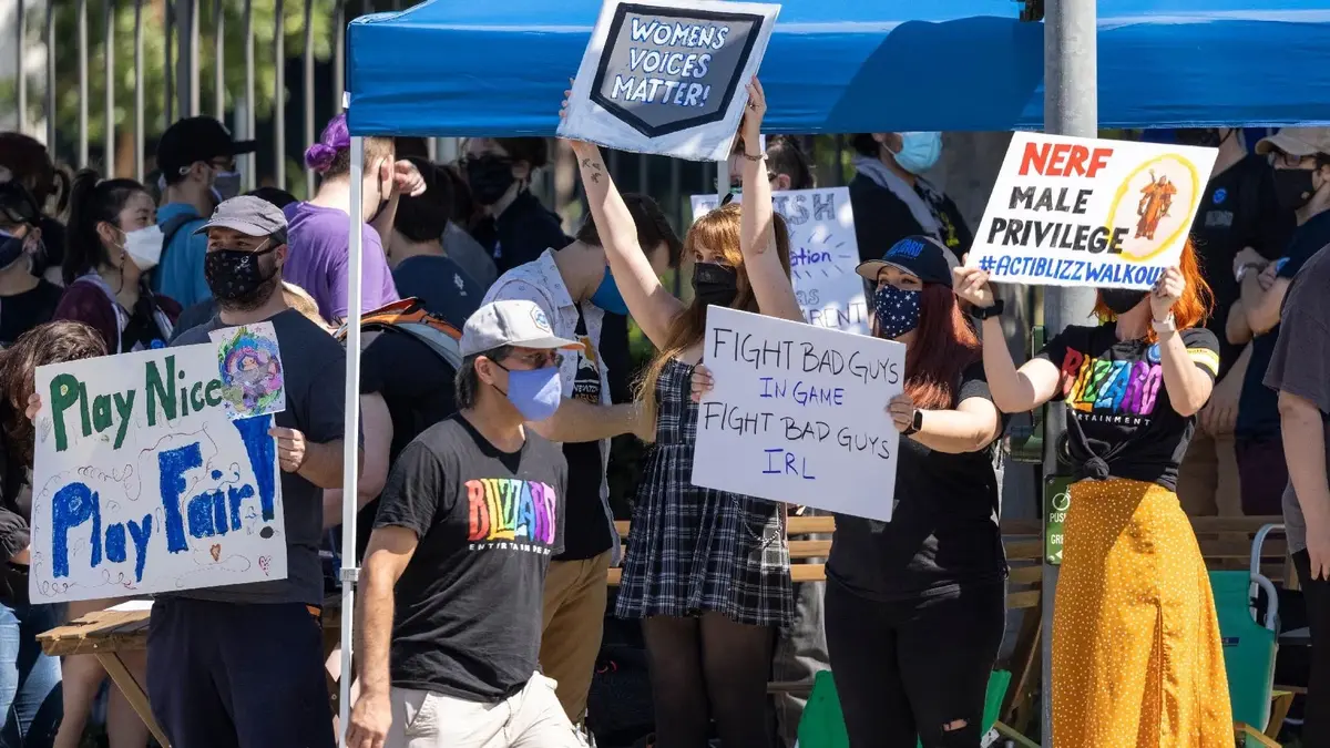 Masked protesters hold signs supporting women and opposing harassment