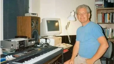 Man sitting at keyboard in home studio