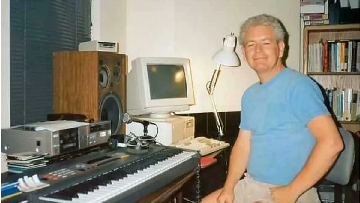 Man sitting at keyboard in home studio