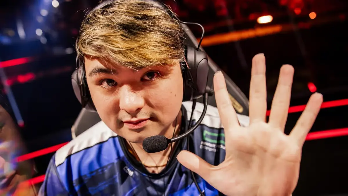 Esports player wearing headset raises open hand