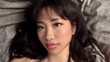 Woman with long hair lying on bed