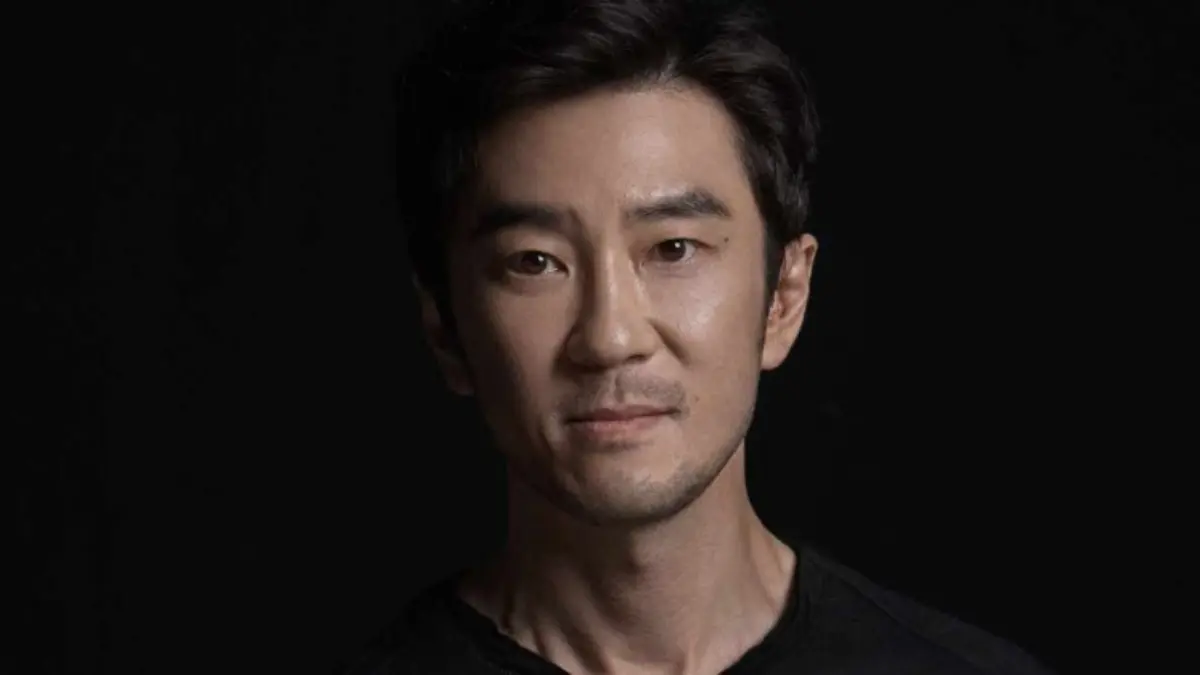 Man posing against dark background