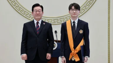 Two men in suits at an award ceremony