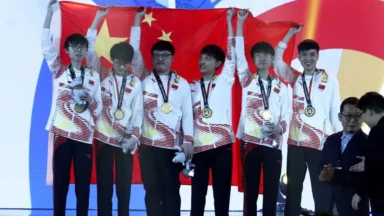 Team holding Chinese flag with gold medals