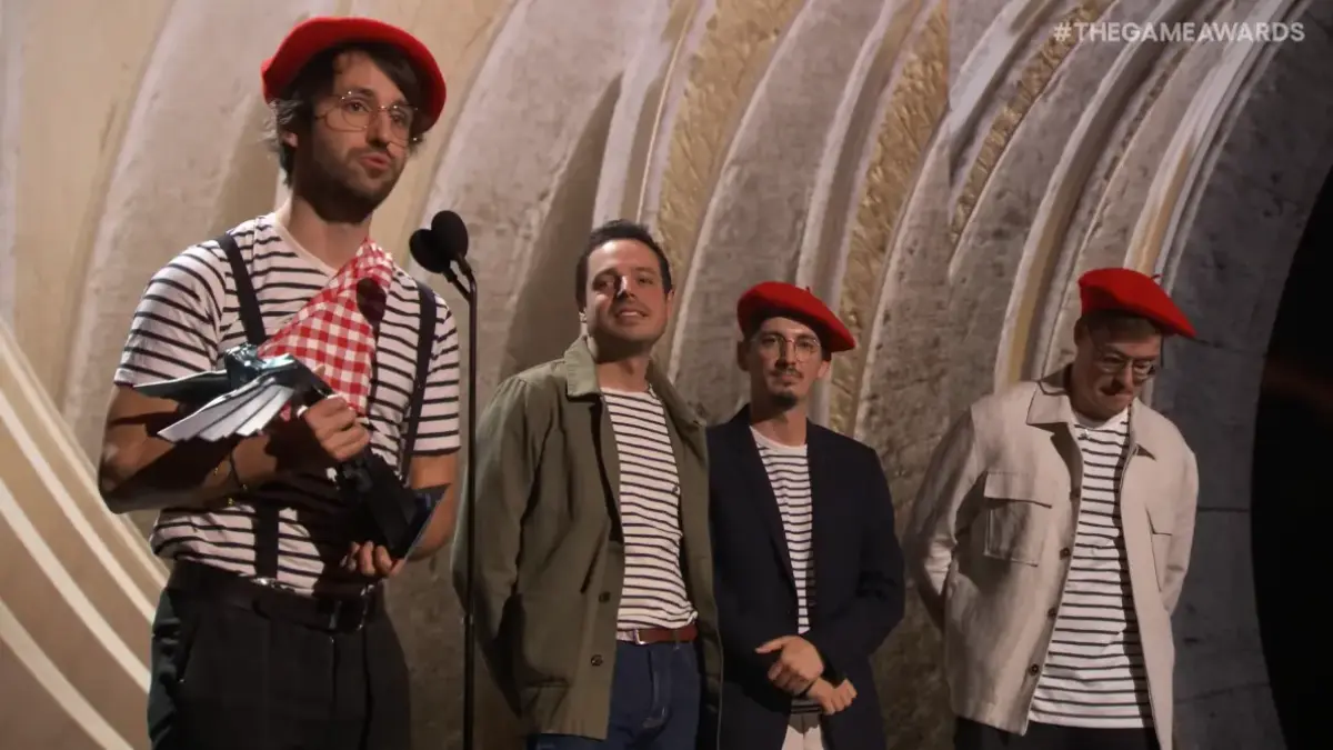 Group accepts award on stage at The Game Awards.