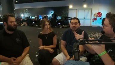 Group discussion at gaming event with microphones.
