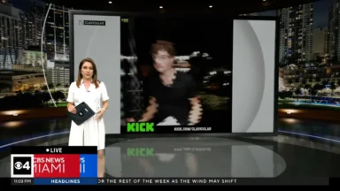 News anchor in studio with large screen display