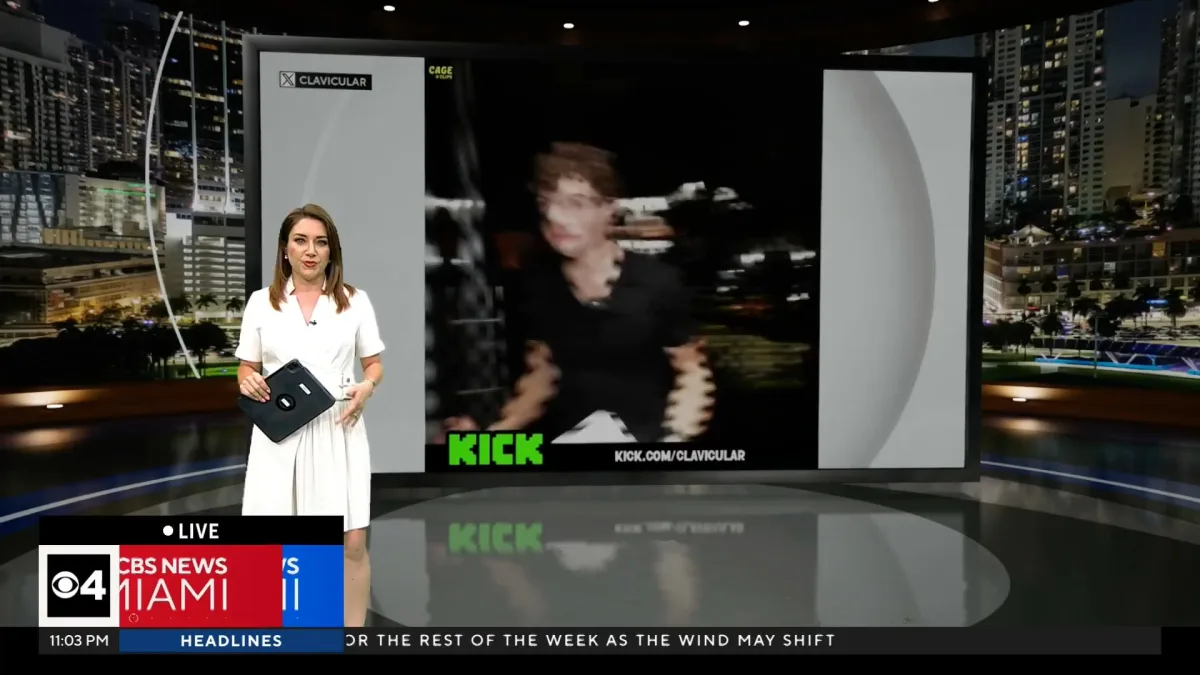 News anchor in studio with large screen display