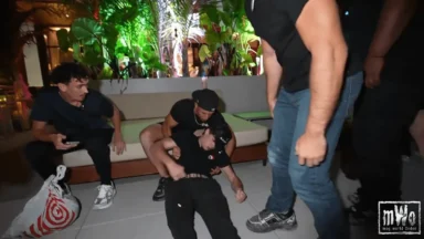 Man lying on floor surrounded by concerned people
