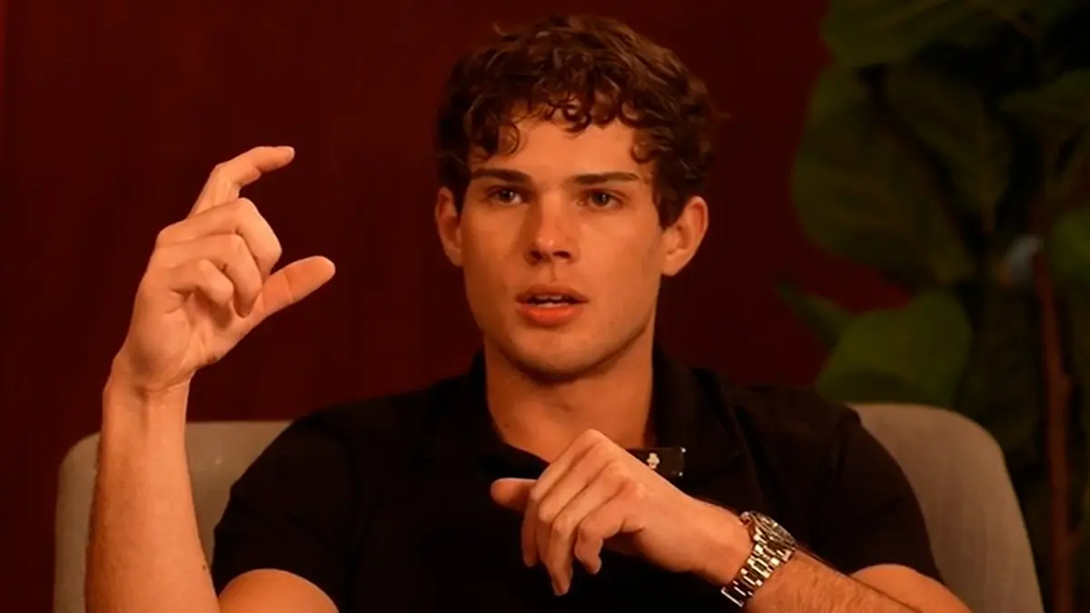 Young man gesturing with fingers close together