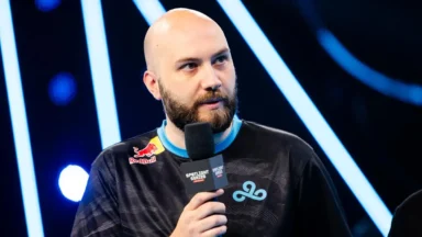 Esports player holding microphone on stage