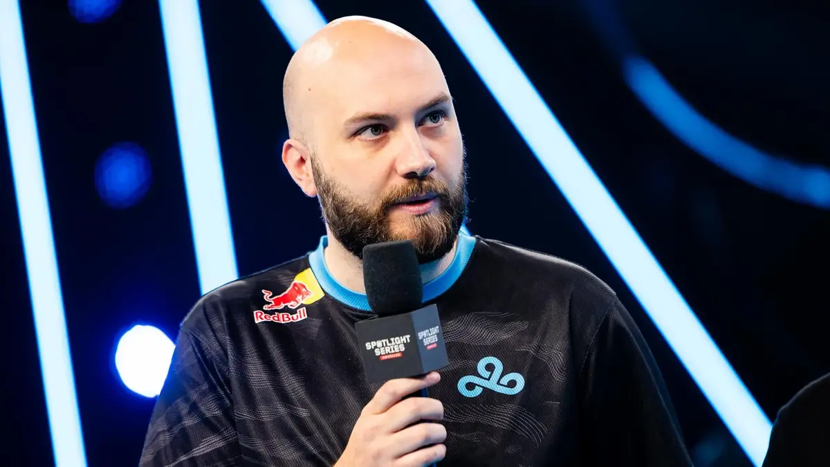 Esports player holding microphone on stage