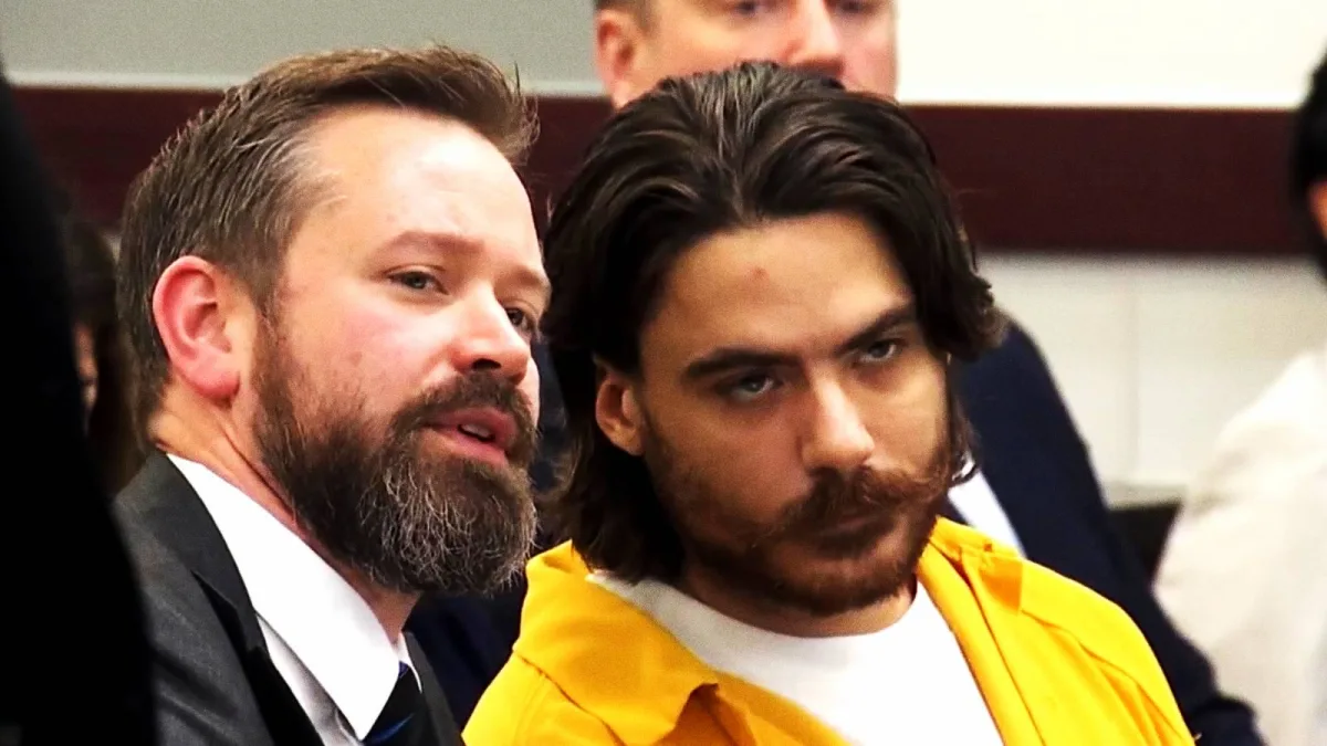 Attorney speaking with defendant in courtroom