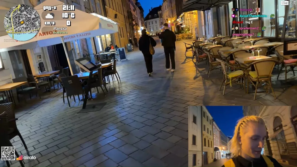 Evening street with outdoor cafes and livestream overlay