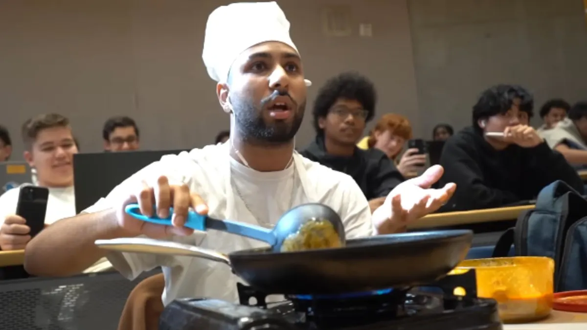 Man cooking in classroom with portable stove
