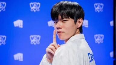 Esports player poses before a blue Worlds backdrop
