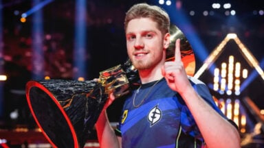 Esports champion holds trophy and raises one finger