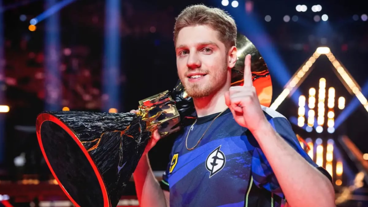 Esports champion holds trophy and raises one finger