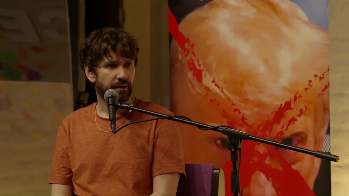 Man speaking into microphone during art event