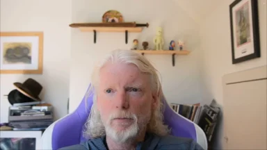 Older man with long white hair indoors