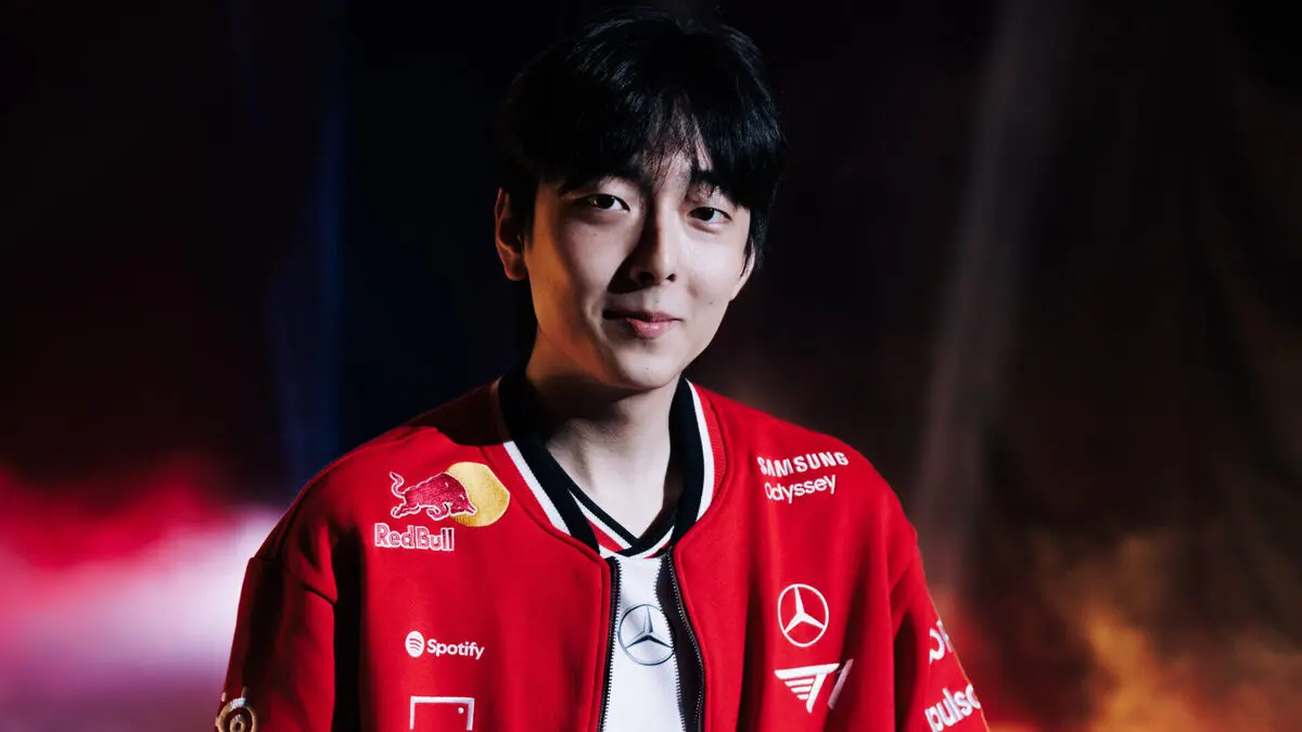 Young man wearing red sponsor-branded jacket indoors