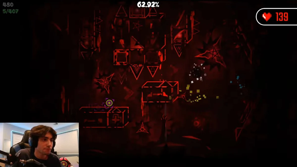 Streamer playing dark red Geometry Dash level