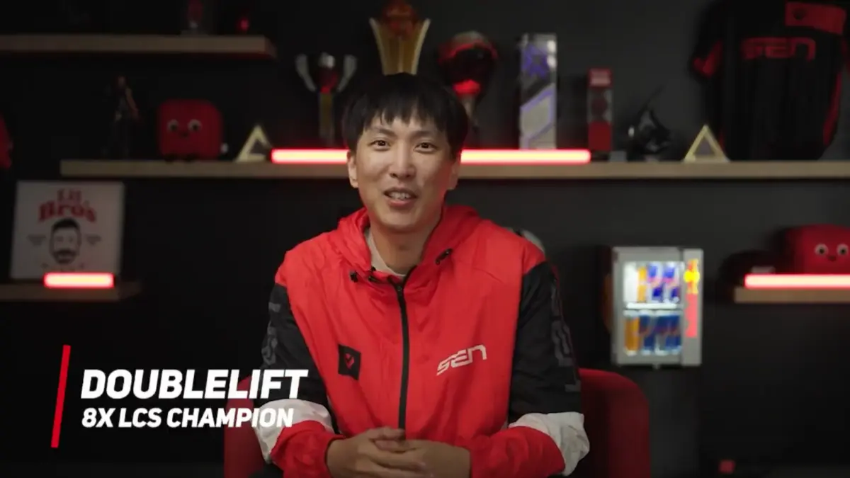 Esports player in red jacket smiling on camera