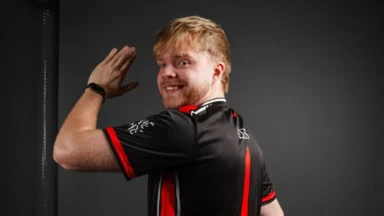 Man flexing arm in black and red jersey