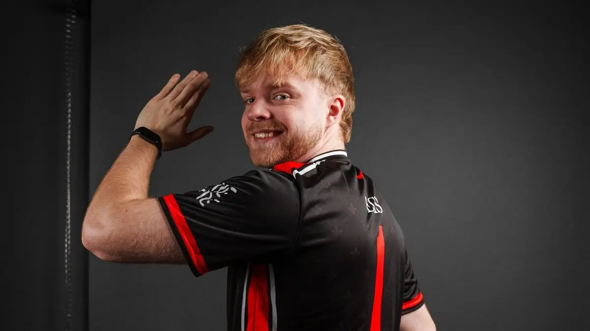 Man flexing arm in black and red jersey