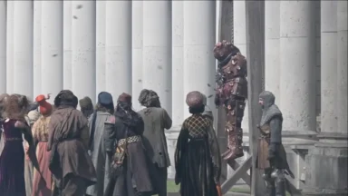 Medieval crowd watching armored figure hanging publicly