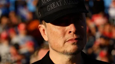 Person wearing a black cap in a crowd.