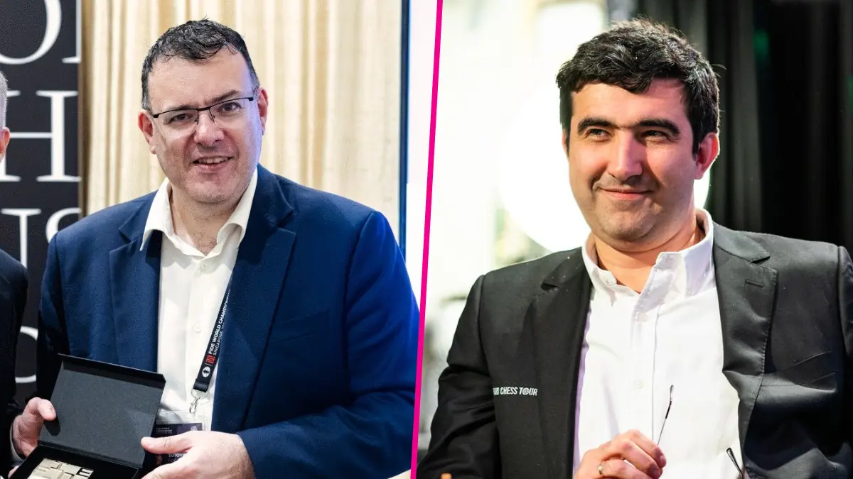 Two men in suits smiling at chess event