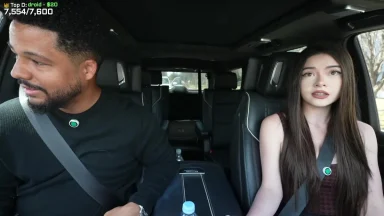 Two people in a car, streaming setup visible.